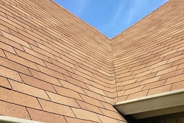 Roof shingles against blue sky