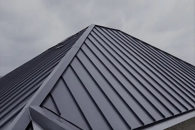Metal roof against cloudy sky